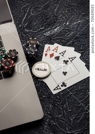 Online casino concept. Gambling chips, cards and dices on laptop keyboard. Vertical image Online casino concept. Gambling chips, cards and dices on laptop keyboard. Vertical image 70689085