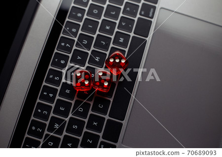 Online casino theme. Red dices on keyboard Online casino theme. Red dices on keyboard 70689093