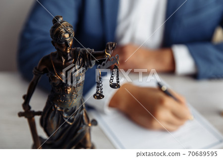 Lawyer office. Statue of Justice with scales close-up and lawyer. Legal law, advice and justice concept 70689595