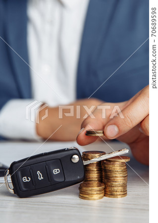 Black car key with contract and money on wooden table. Concept business finance and insurance 70689598