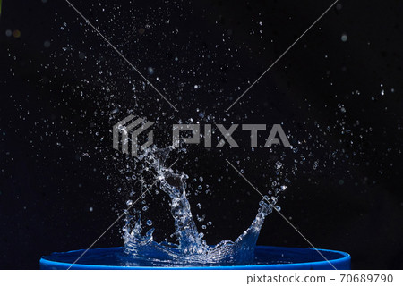 Blue water drops falling down. 70689790