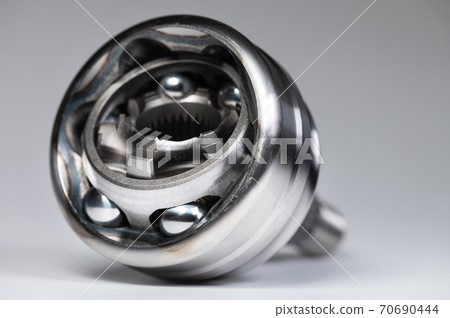 CV joint new with copy space on gray background. Shallow depth of field new metal detail. Background new spare parts 70690444