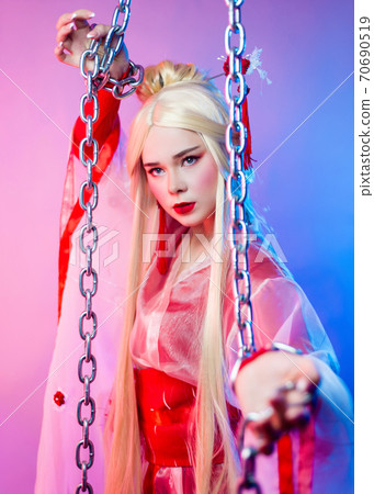 a woman in a geisha costume chained in large chains a woman in a geisha costume chained in large chains 70690519