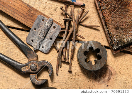 Old vintage household hand tools still life on a wooden background in a DIY and repair concept Old vintage household hand tools still life on a wooden background in a DIY and repair concept 70691323