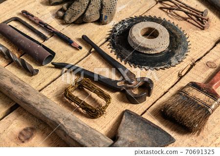 Old vintage household hand tools still life on a wooden background in a DIY and repair concept 70691325