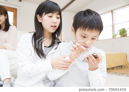 Kids playing smartphone games Kids playing smartphone games 70691439