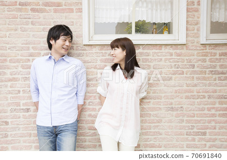 Men and women standing in front of the wall Men and women standing in front of the wall 70691840