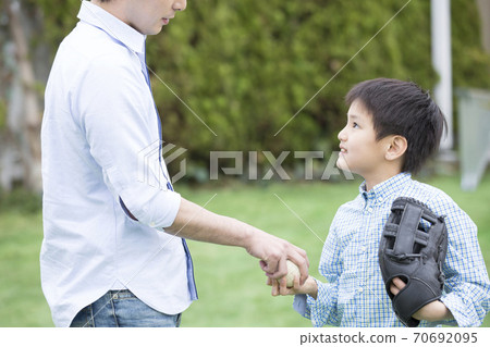 Father and son playing catch 70692095