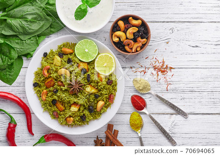 Palak Paneer Biryani and Raita at white background with. Vegetarian indian cuisine dish Palak Paneer Biryani and Raita at white background with. Vegetarian indian cuisine dish 70694065