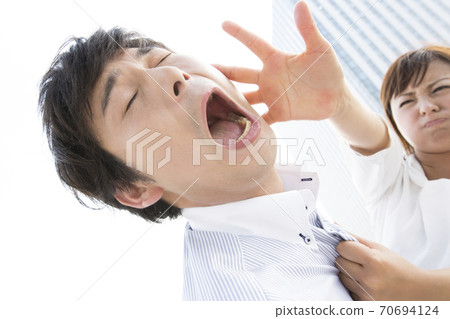 A man who is slapped by a woman 70694124