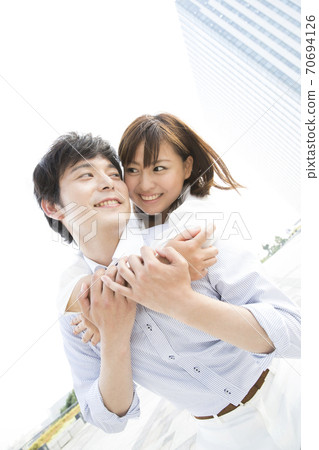 Couple hugging from behind 70694126