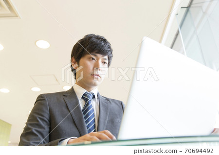 A businessman doing a laptop computer 70694492