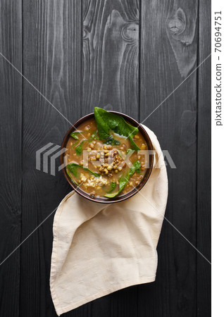 Spinach Mung Dhal and Chapati on black wooden table top. Moong Dal - Indian Cuisine curry. 70694751