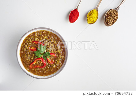 Mung Dhal isolated on white. Moong Dal - Indian Cuisine curry. Mung Dhal isolated on white. Moong Dal - Indian Cuisine curry. 70694752