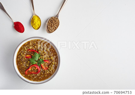 Mung Dhal isolated on white. Moong Dal - Indian Cuisine curry. 70694753