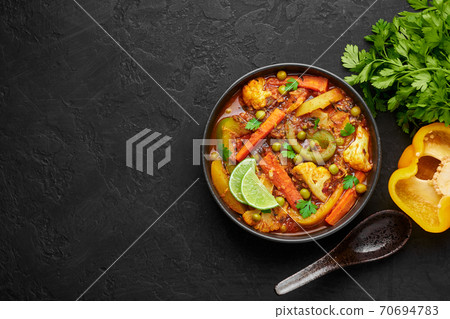 Veg Kolhapuri in black bowl on dark slate table top. Indian vegetable curry. Vegetarian asian food 70694783