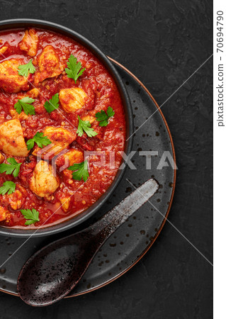 Chicken Madras Curry in black bowl on dark slate table top. Indian cuisine dish with. Asian food  70694790