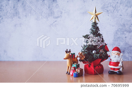 Christmas decoration - Santa Clause, tree and gift on wooden table. Christmas and Happy new year concept Christmas decoration - Santa Clause, tree and gift on wooden table. Christmas and Happy new year concept 70695999