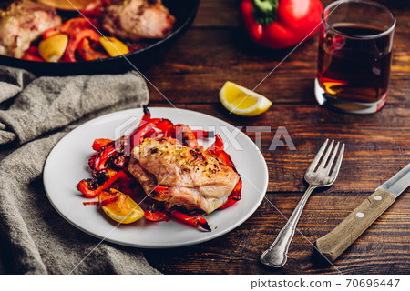 Baked chicken thighs with red bell peppers and lemon Baked chicken thighs with red bell peppers and lemon 70696447