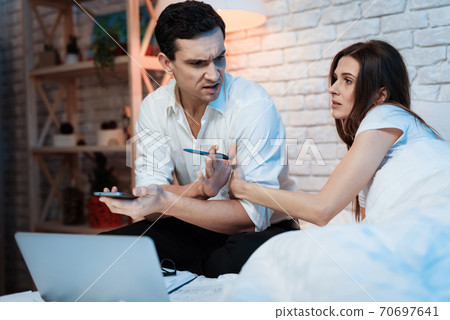 Young girl distracts man from work.  70697641