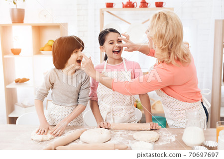 Attractive grandmother smeared with flour nose. Attractive grandmother smeared with flour nose. 70697697
