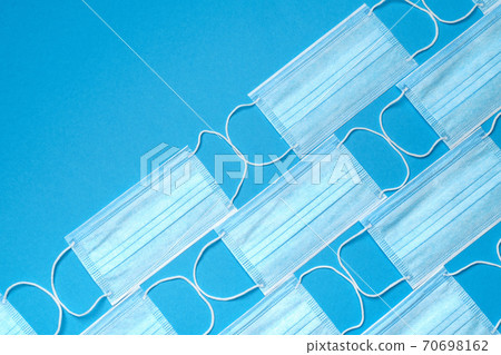 coronavirus COVID-19 pandemic concept - background made of antiviral surgical protective medical masks coronavirus COVID-19 pandemic concept - background made of antiviral surgical protective medical masks 70698162