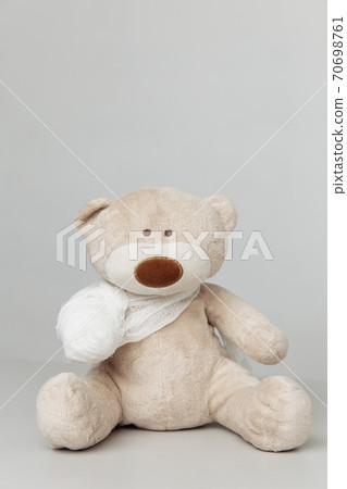 Teddy Bear animal with bandage as a symbol of children healtcare concept Teddy Bear animal with bandage as a symbol of children healtcare concept 70698761
