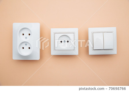 Power sockets and switch on pink table. Power energy economy Power sockets and switch on pink table. Power energy economy 70698766