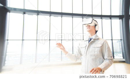 A man watching a video wearing VR goggles 70698821
