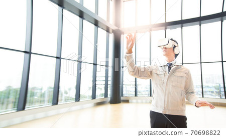 A man watching a video wearing VR goggles 70698822