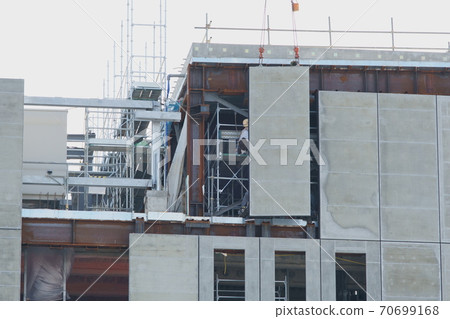 Installation work of concrete wall at construction site Installation work of concrete wall at construction site 70699168