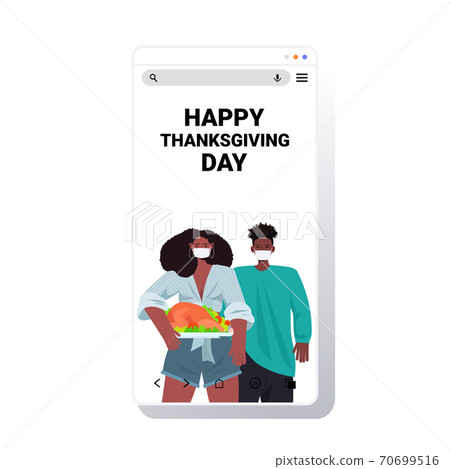 man woman in masks celebrating happy thanksgiving day african american couple holding roasted turkey coronavirus man woman in masks celebrating happy thanksgiving day african american couple holding roasted turkey coronavirus 70699516