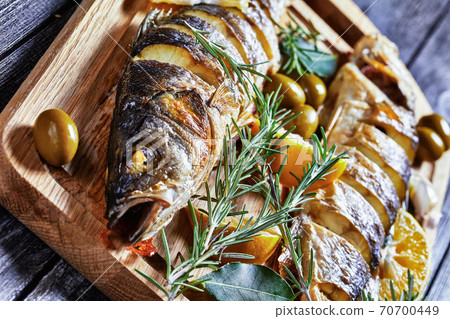 Roasted seabass with olives and tartar sauce Roasted seabass with olives and tartar sauce 70700449