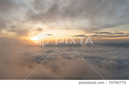 Aerial view of sunset above fluffy sea fog misty clouds with mountain hill from Phu Tub Berk, Khao Kho, Phetchabun with sunlight. Abstract nature landscape background at twilight time. 70700770