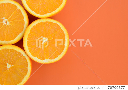 Top view of a several orange fruit slices on bright background in orange color. A saturated citrus texture image Top view of a several orange fruit slices on bright background in orange color. A saturated citrus texture image 70700877