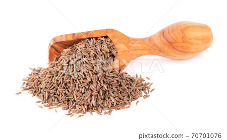 Cumin seeds in wooden scoop, isolated on white background. Cumin seeds or caraway. Cumin seeds in wooden scoop, isolated on white background. Cumin seeds or caraway. 70701076