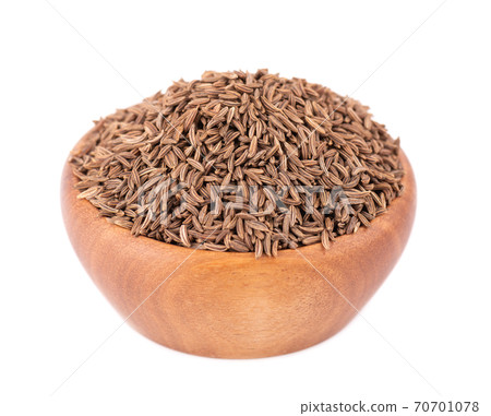Cumin seeds in wooden bowl, isolated on white background. Cumin seeds or caraway. Cumin seeds in wooden bowl, isolated on white background. Cumin seeds or caraway. 70701078