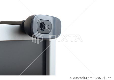 A modern web camera is installed on the body of a flat screen monitor. Device for video communication and recording of high quality video 70701266