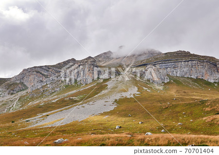 beautiful autumn mountain landscape with rocky peak in the clouds beautiful autumn mountain landscape with rocky peak in the clouds 70701404