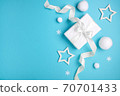 Christmas composition, gift box and white balls on blue background, minimalism. 70701433
