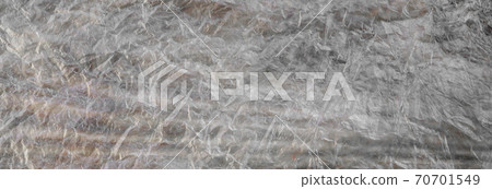 Texture of cellophane material with many folds and bends Texture of cellophane material with many folds and bends 70701549