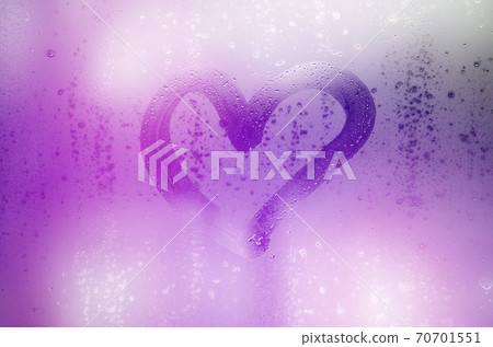 The heart is painted on the misted glass in the winter The heart is painted on the misted glass in the winter 70701551