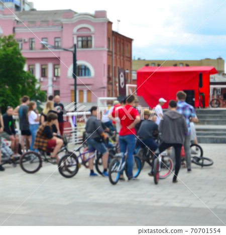 Defocused image of a lot of people with bmx bikes. Meeting of fans of extreme sports 70701554