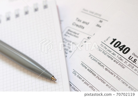 The pen and notebook is lies on the tax form 1040 U.S. Individual Income Tax Return. The time to pay taxes The pen and notebook is lies on the tax form 1040 U.S. Individual Income Tax Return. The time to pay taxes 70702119