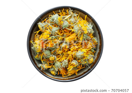 Healthy calendula flowers. Bowl of dry marigold petals, isolated on white. Herbal medicine. 70704057