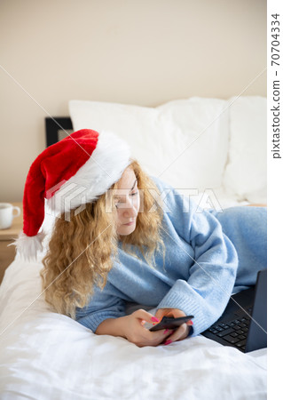 Woman with smartphone and laptop Woman with smartphone and laptop 70704334