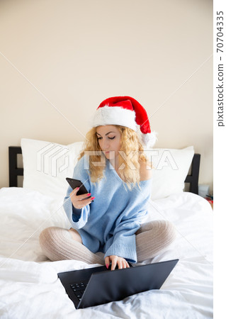 Woman with smartphone and laptop Woman with smartphone and laptop 70704335
