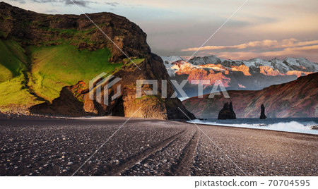Famous Reynisdrangar rock formations at black Reynisfjara Beach. Coast of the Atlantic ocean near Vik, southern Iceland 70704595