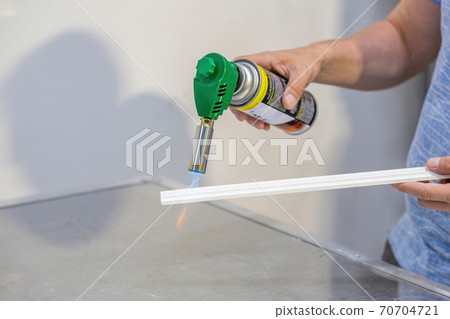 A worker checks the product for fire resistance A worker checks the product for fire resistance 70704721