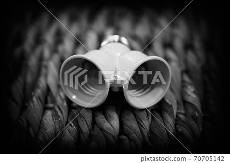 Electric base for a light bulb on a wicker background 70705142